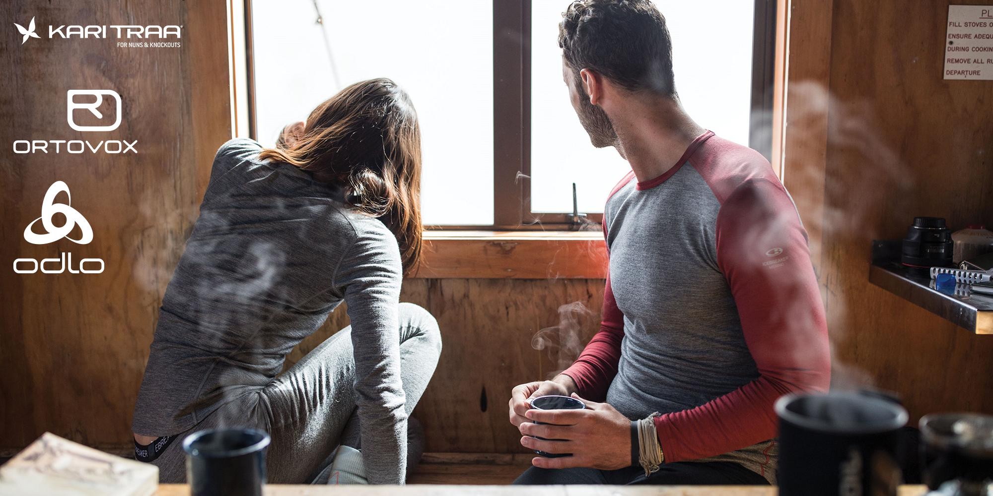 Ein Mann und eine Frau sitzen nach dem Skifahren bei einem Hei&szlig;getr&auml;nk in der Ski-H&uuml;tte