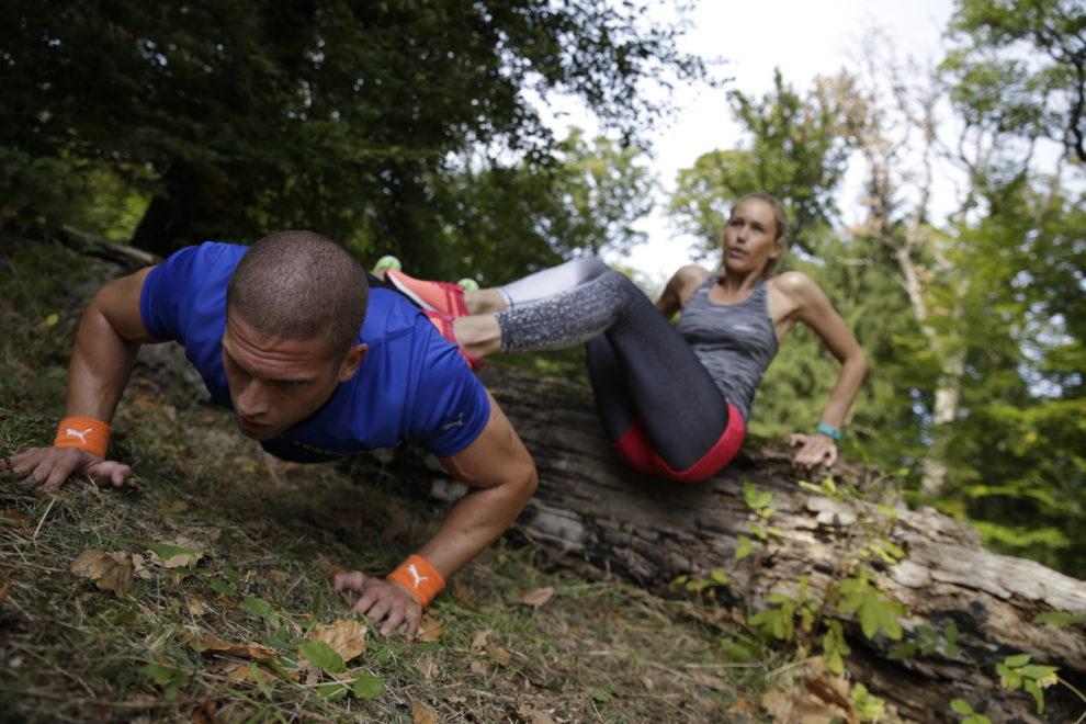 Ein Mann und eine Frau trainieren im Wald gemeinsam Liegest&uuml;tze.