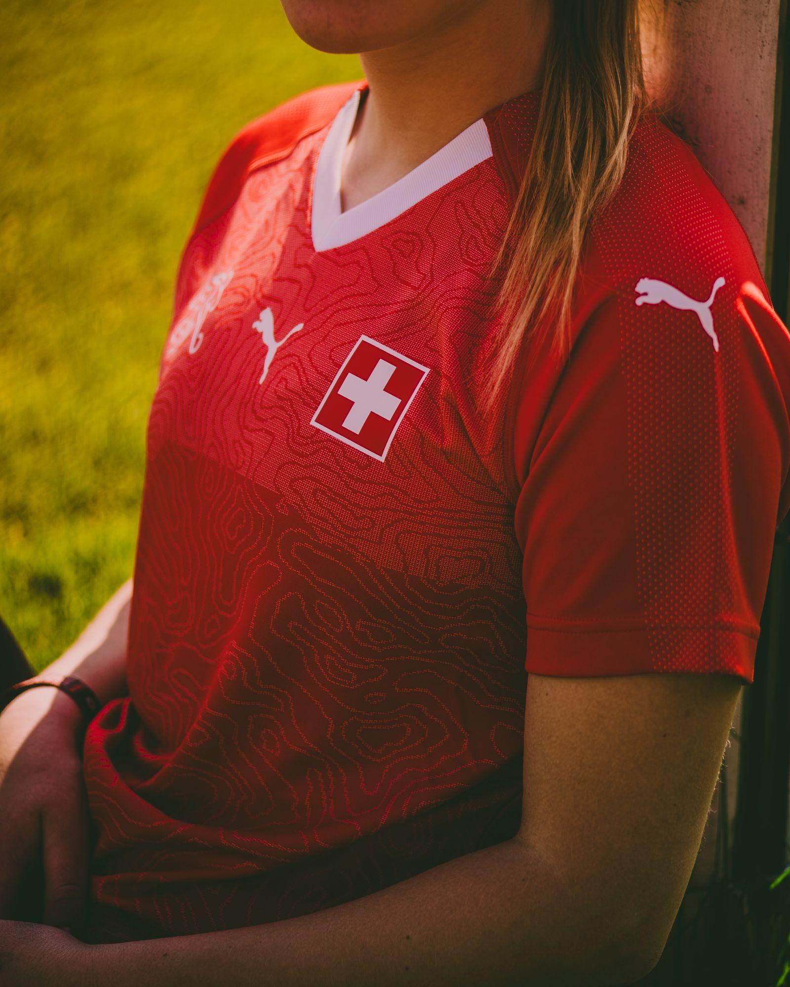 Ein Mann bedruckt mit einer Textilpresse einen Fußballschuh.