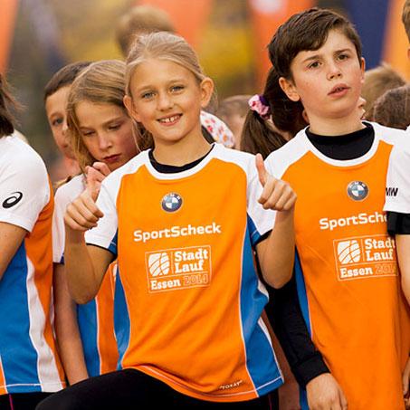 Kinder mit Sportscheck-Shirts bei einem Stadtlauf