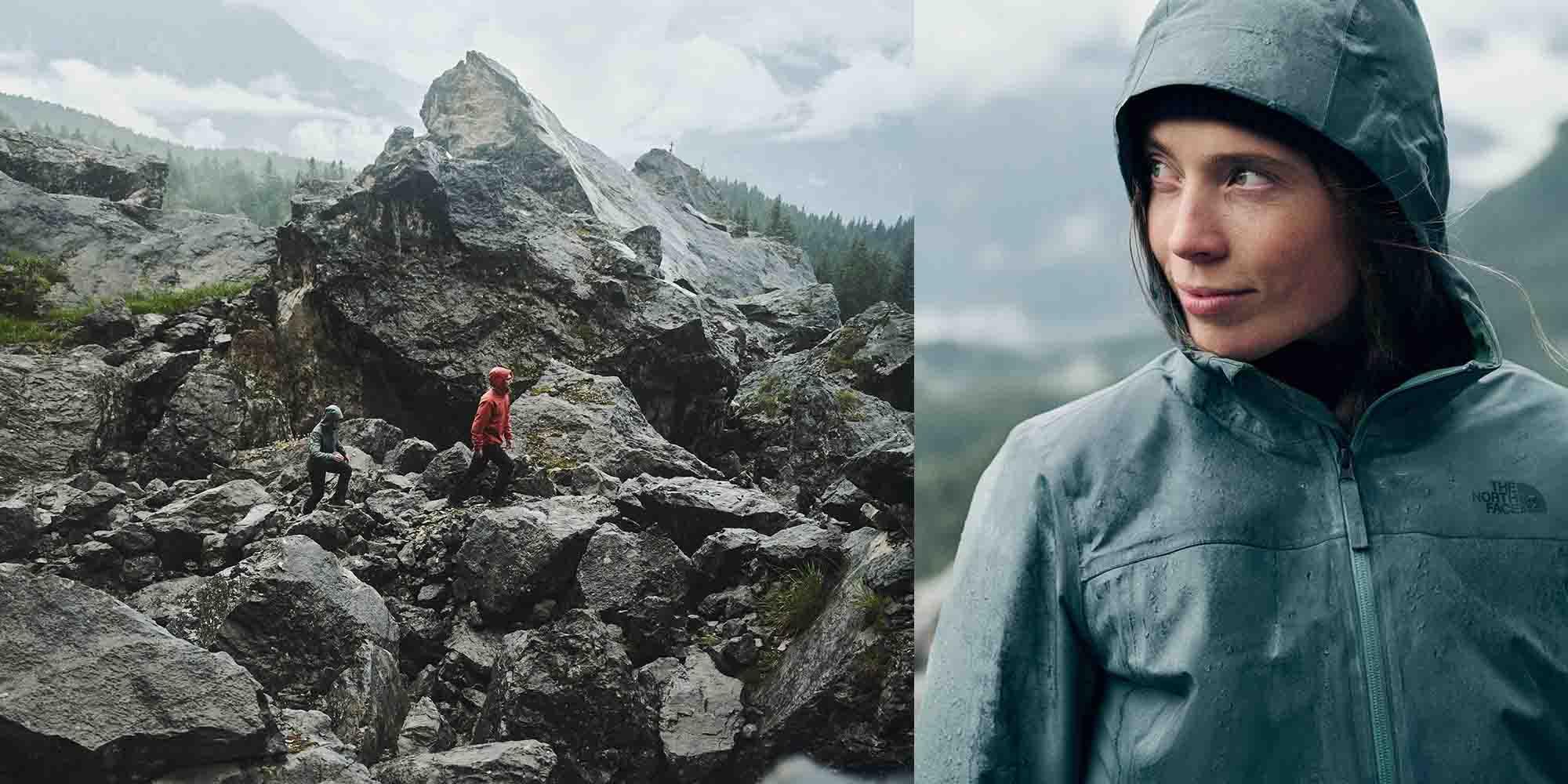 Menschen tragen Regenjacken in einer steinigen herbstlichen Natur