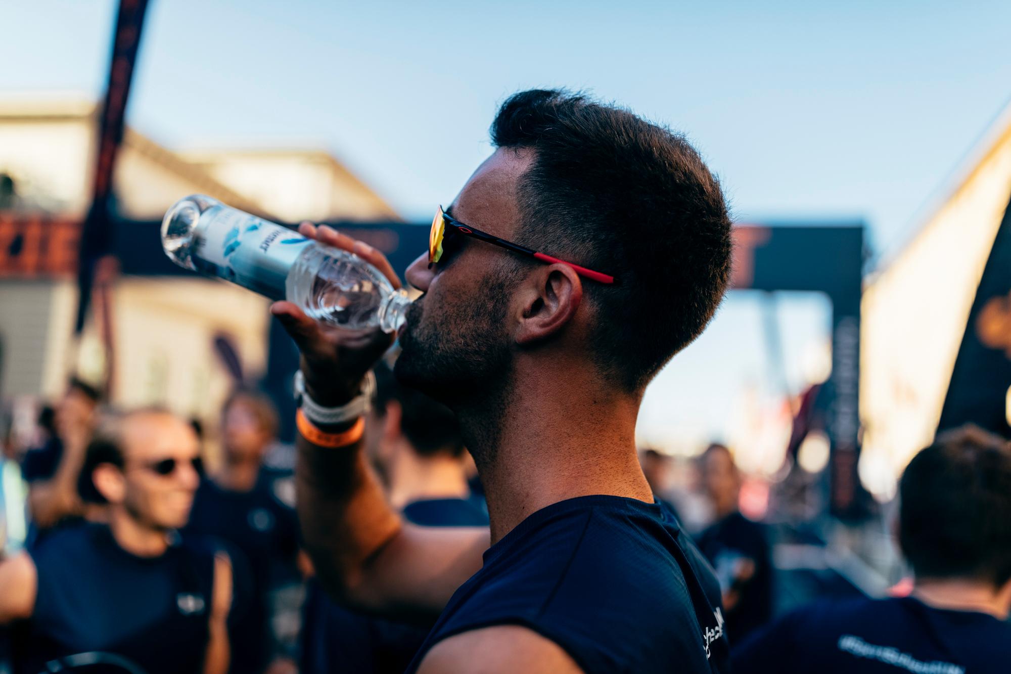 Ein L&auml;ufer trinkt Wasser aus einer Flasche