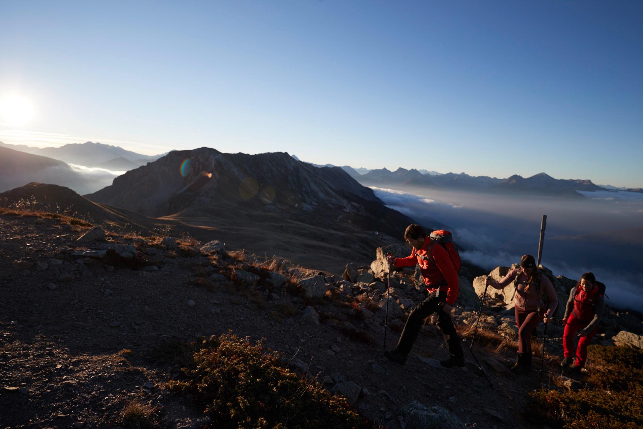 Eine Gruppe von Wanderern ist auf einem Bergpfad unterwegs.